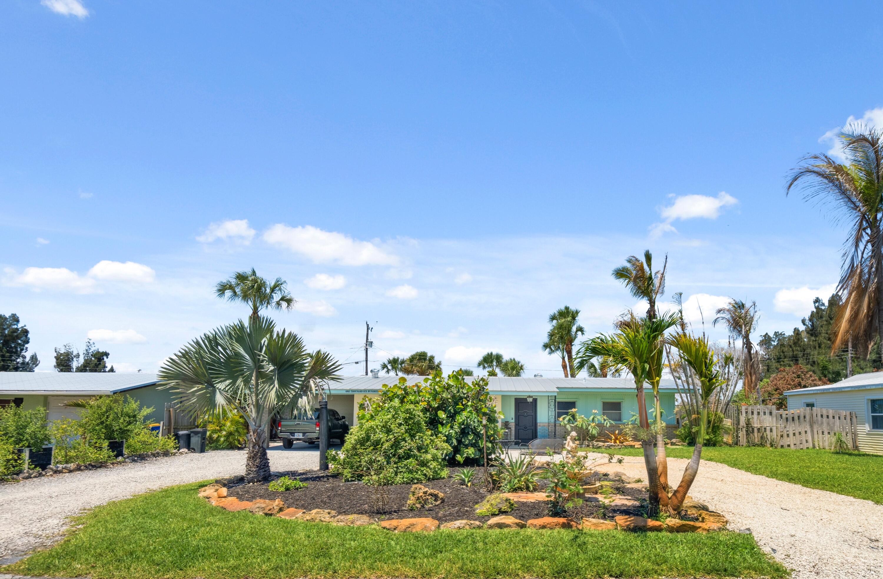 A warm Southwest Florida home with palm trees under a bright sky